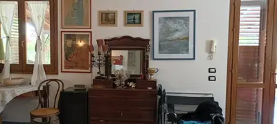 a living room with a dresser and a mirror at Villetta sulla Valle in Castellammare del Golfo