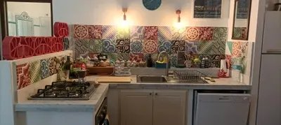 a kitchen with a sink and a stove top oven at Villetta sulla Valle in Castellammare del Golfo
