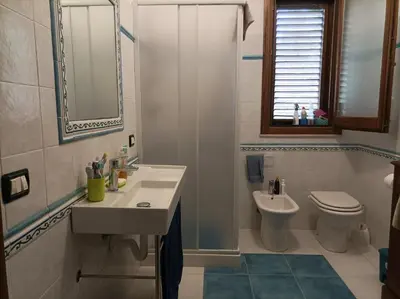 a bathroom with a sink and a toilet at Villetta sulla Valle in Castellammare del Golfo