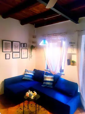 a living room with a blue couch and a table at Palermo Al Capo in Palermo