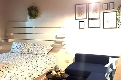 a bedroom with a bed and a blue couch at Palermo Al Capo in Palermo