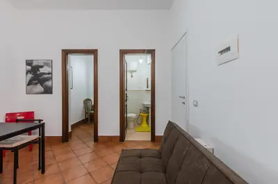 a living room with a couch and a table at GuestHost - Teatro Politeama Functional Studio x4 in Palermo