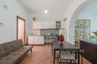 a living room with a couch and a table at GuestHost - Teatro Politeama Functional Studio x4 in Palermo