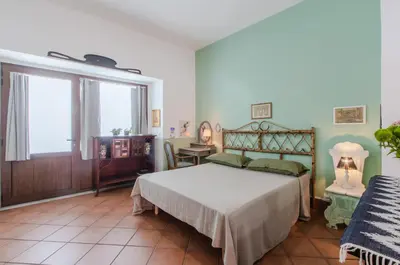 a bedroom with a bed and a table and a window at GuestHost - Teatro Politeama Functional Studio x4 in Palermo