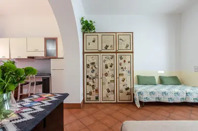 a living room with a couch in the corner of a room at GuestHost - Teatro Politeama Functional Studio x4 in Palermo