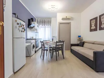 a kitchen and living room with a table and a couch at Apartment La Casetta di Clò by Interhome in Palermo