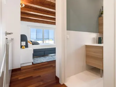 a bedroom with a bed and a view of the ocean at Apartment Quirat Superior by Interhome in Terrasini