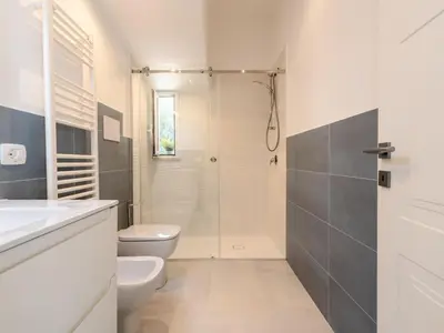 a white bathroom with a shower and a toilet at Apartment Quirat Superior by Interhome in Terrasini