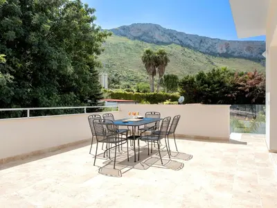 a table and chairs on a patio with a view at Apartment Quirat Superior by Interhome in Terrasini