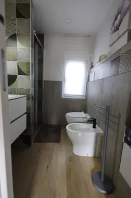 a bathroom with a toilet and a shower and a sink at Al Cottage Isola Delle Femmine in Isola delle Femmine