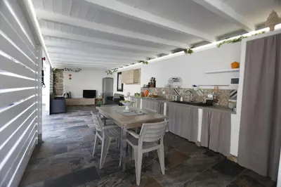 a group of chairs and a table in a room at Al Cottage Isola Delle Femmine in Isola delle Femmine