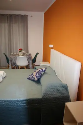 a bedroom with a bed and a table with a tableablish at DUE CAPPUCCINI in Palermo
