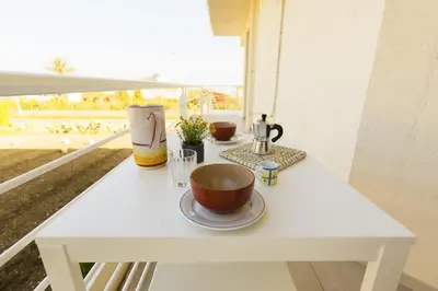 a white table with two cups on top of it at Visitsicilia Rosetta Mare in Alcamo Marina