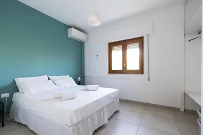 a bedroom with two beds and a window at Visitsicilia Rosetta Mare in Alcamo Marina