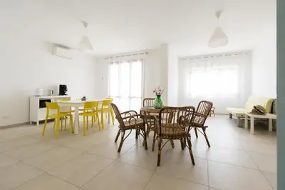 a dining room with yellow chairs and a table at Visitsicilia Rosetta Mare in Alcamo Marina