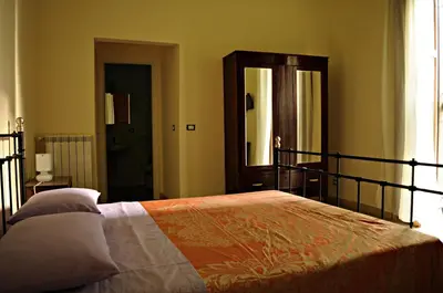 a bedroom with a bed and a large mirror at B&B Palazzo Corvino in Palermo
