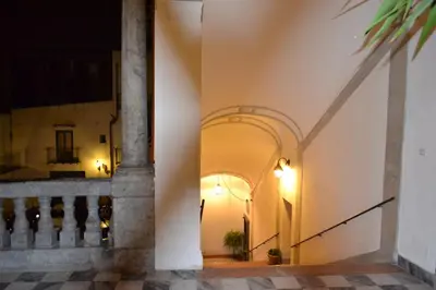 a hallway of a building with an archway at B&B Palazzo Corvino in Palermo