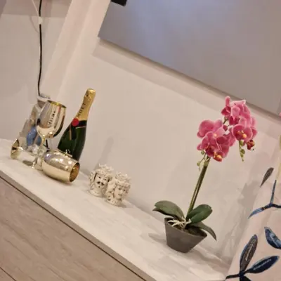 a flower in a vase sitting on a shelf at Villa Margot Mondello in Palermo