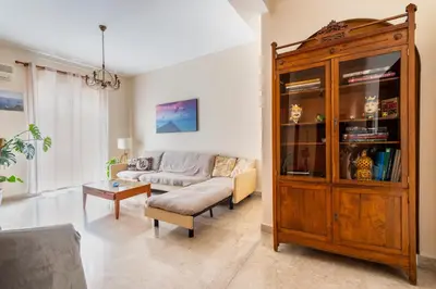 a living room with a couch and a wooden cabinet at Casa Lov (Politeama) in Palermo