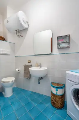 a bathroom with a toilet sink and a washing machine at Casa Lov (Politeama) in Palermo
