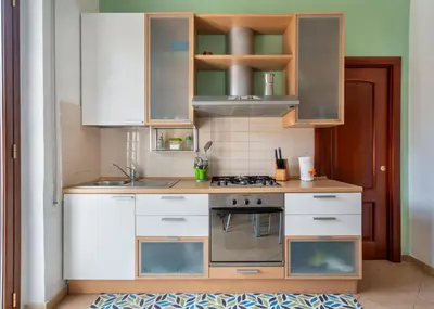 a kitchen with white cabinets and a stove at Casa Lov (Politeama) in Palermo