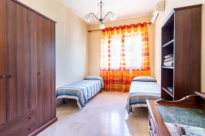 a room with two beds and a window at Casa Lov (Politeama) in Palermo
