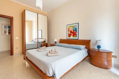 a bedroom with a bed and a large mirror at Casa Lov (Politeama) in Palermo