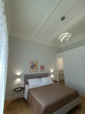 a bedroom with a bed and a white ceiling at Casa Ranzano in Palermo