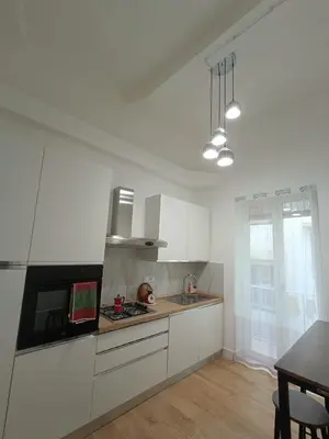 a kitchen with white cabinets and a stove top oven at Casa Ranzano in Palermo