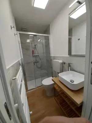 a bathroom with a shower and a toilet and a sink at Casa Ranzano in Palermo