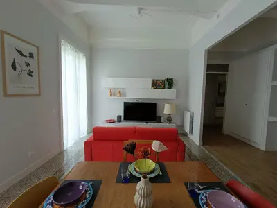 a living room with a red couch and a table at Casa Ranzano in Palermo