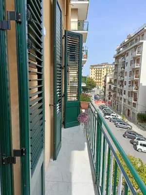 a balcony with a green door and a city street at Casa Ranzano in Palermo