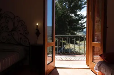 a room with a door open to a balcony with a view at Casa Sally con Vista Mare a Macari in Macari
