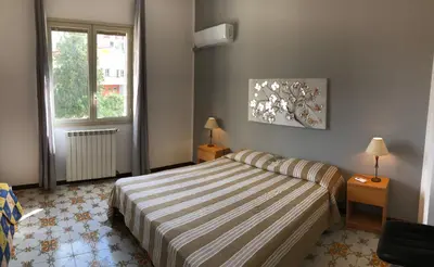 a bedroom with a bed and a window at Villa Gelvi in Castellammare del Golfo