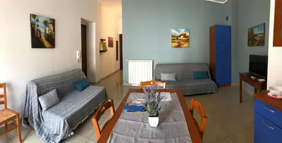 a living room with a table and a couch at Villa Gelvi in Castellammare del Golfo