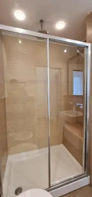 a shower with a glass door in a bathroom at Di Fresco Apartments Luxury Suites in Palermo