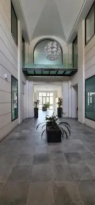 a large empty room with plants in a building at Di Fresco Apartments Luxury Suites in Palermo
