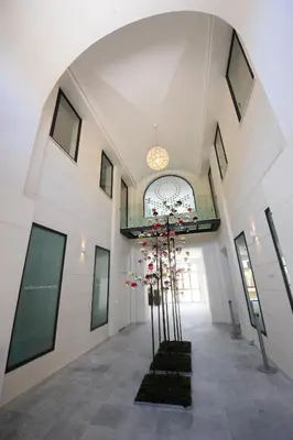 a hallway with a plant in the middle of a building at Di Fresco Apartments Luxury Suites in Palermo