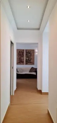 a white room with a bed and a wooden floor at Di Fresco Apartments Luxury Suites in Palermo