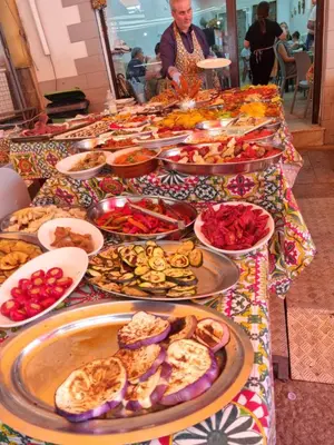 a table with many plates of food on it at Giardino Moreno in Palermo
