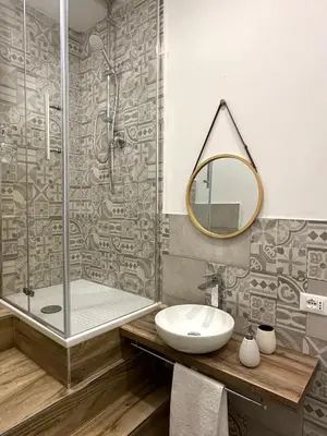 a bathroom with a shower and a sink and a mirror at Il Moro in Carini