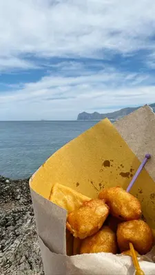 a box of food sitting on top of the ocean at Il Moro in Carini