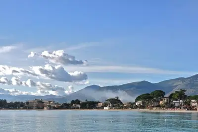 a body of water with mountains in the background at The k house in Palermo