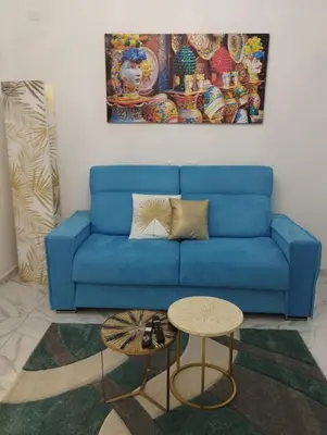 a blue couch in a living room with a table at casa nike in Palermo