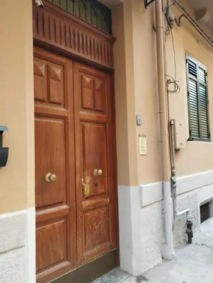 a large wooden door on the side of a building at casa nike in Palermo