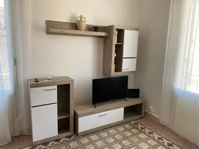 a living room with a tv on a wall at Al Parlatoio del Centro Storico in Palermo