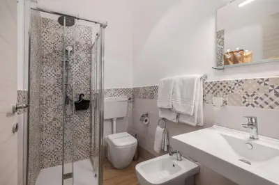 a bathroom with a toilet and a sink and a shower at LA VECCHIA PALERMO in Palermo