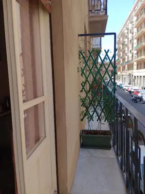 a balcony with a door and a potted plant at LA VECCHIA PALERMO in Palermo