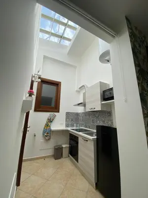 a kitchen with a sink and a stove top oven at Quattrociocchi apartment in Bagheria