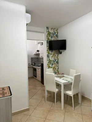 a kitchen and dining room with a table and chairs at Quattrociocchi apartment in Bagheria